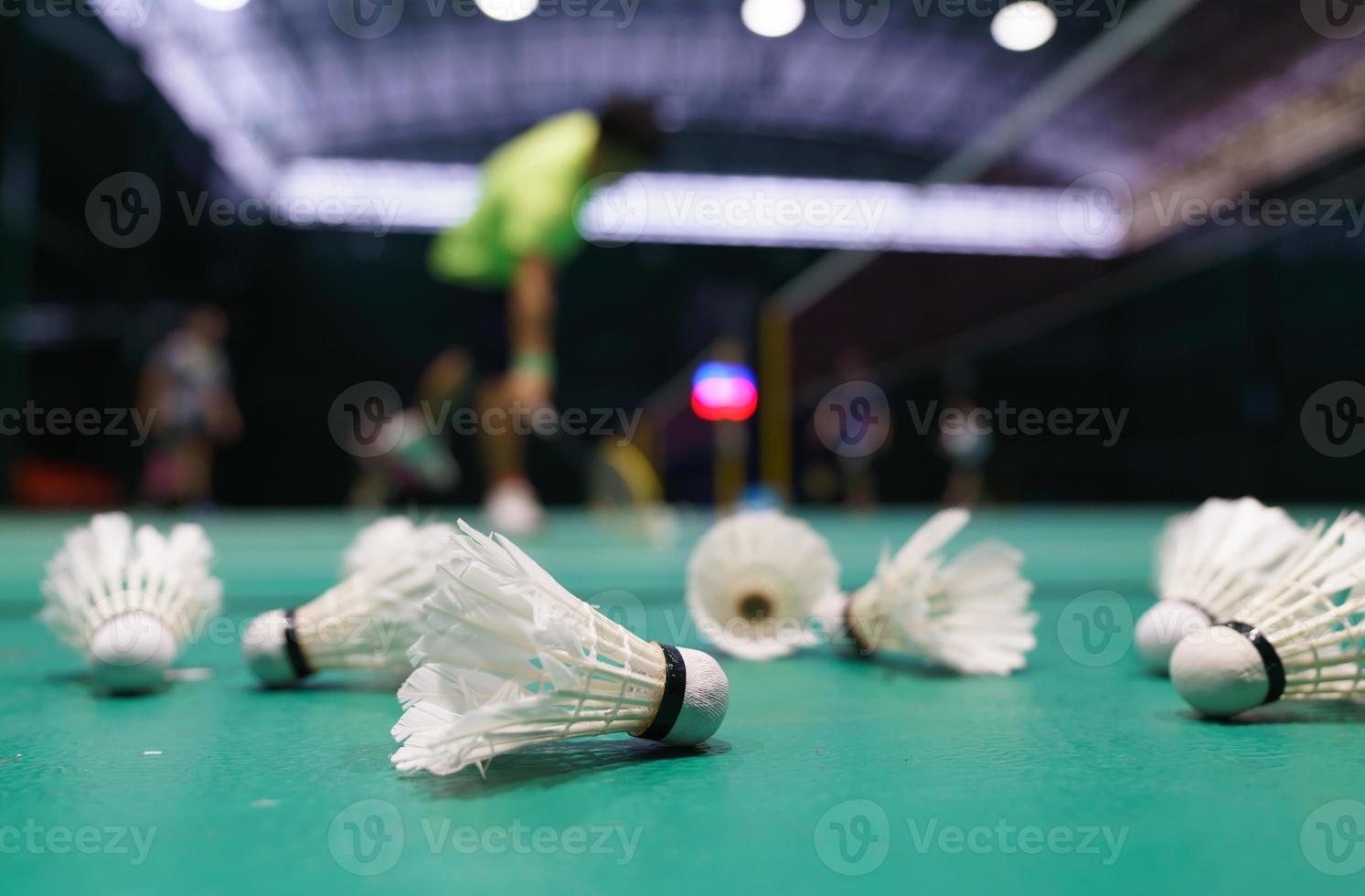 volant sur le terrain de jeu de badminton vert photo