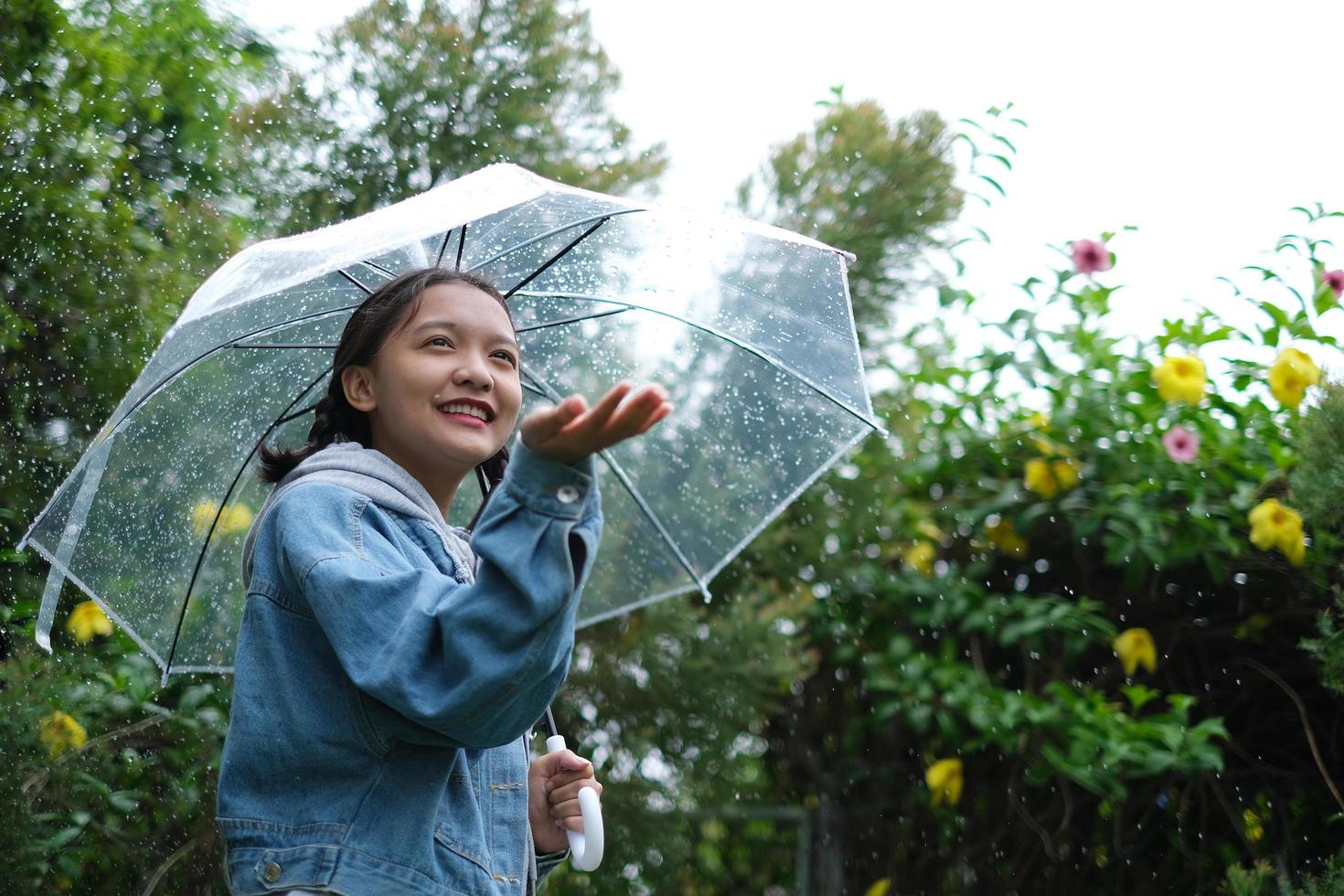 sourire jeune fille s'amusant sous la pluie. photo
