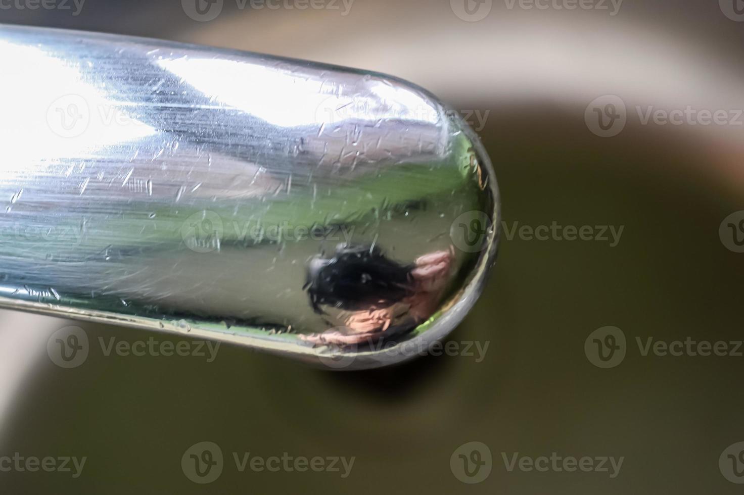 l'eau courante d'un robinet d'eau dans le drain d'un évier chromé. photo