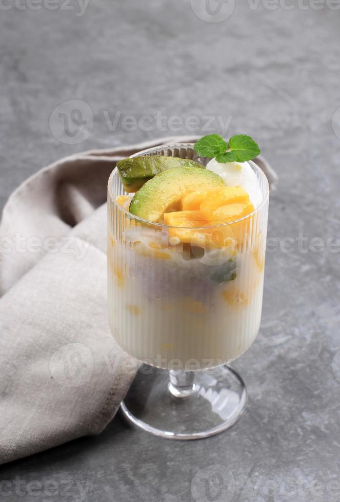 es teler, es teller, es campur, est un cocktail de fruits indonésien. avocat, jeune chair de noix de coco, jacquier et sirop simple, servi avec du lait de coco ou du lait concentré sucré. photo