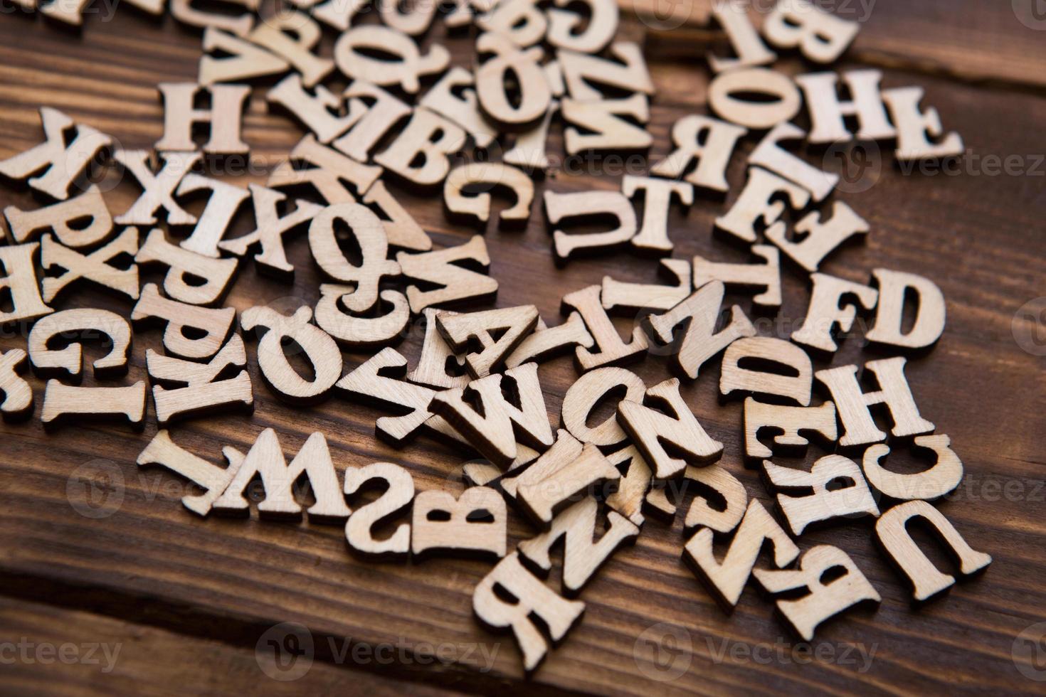 lettres de l'alphabet anglais sur un fond en bois foncé. le concept d'éducation, de jeux de mots, de travaux d'aiguille. espace pour le texte photo