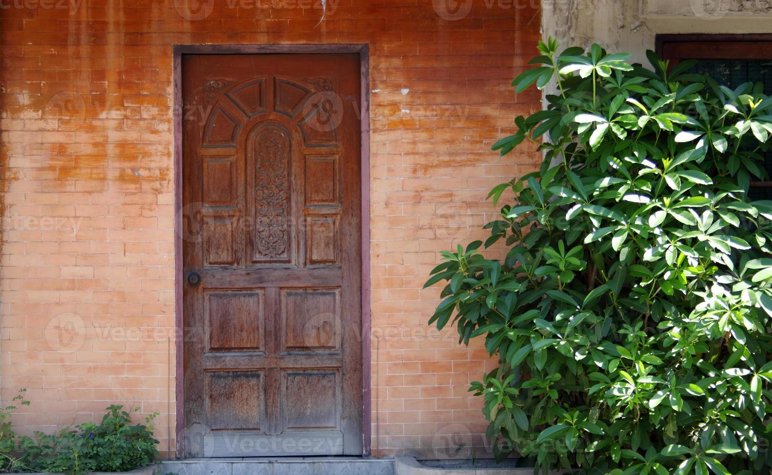 porte en bois de style ancien et mur de briques. photo