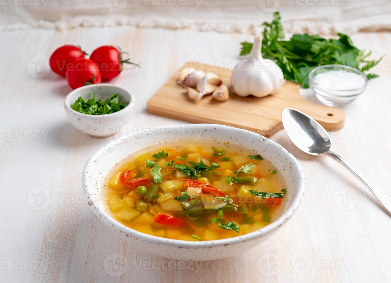 soupe végétarienne diététique aux légumes de printemps sains, fond en bois blanc, vue latérale, gros plan photo