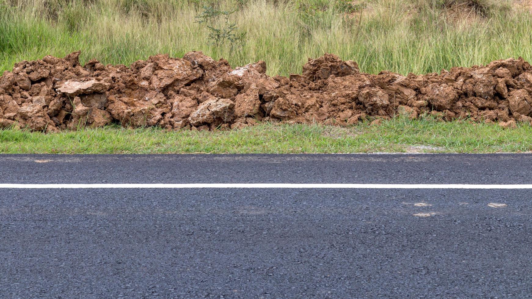 surface de la route asphaltée avec un tas de terre. photo