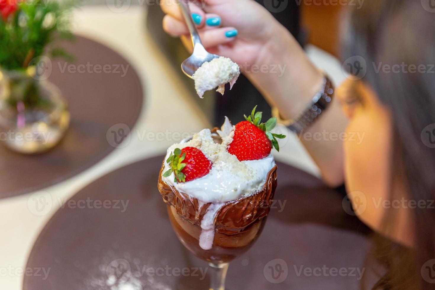 la crème glacée blanche mélange la fraise avec beaucoup de calories, peut vous faire grossir, flouter. délicieux sundae à la vanille ou au chocolat avec fraise. photo