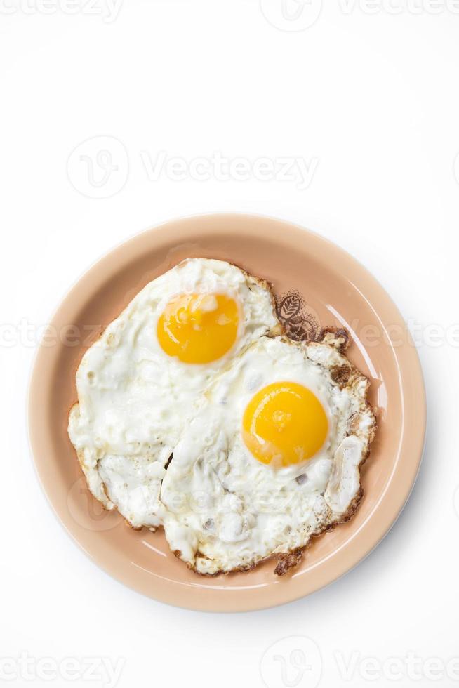 deux oeufs au plat dans une assiette photo