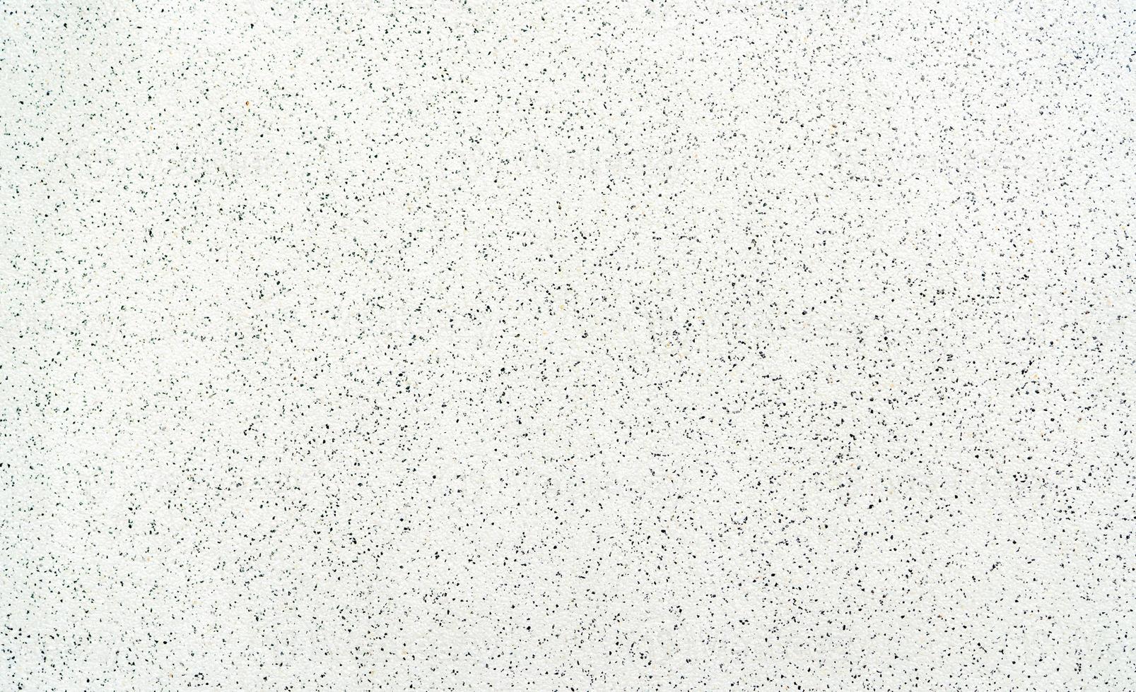 motif noir et blanc de fond de texture de sol en terrazzo. sol en terrazzo. modèle sans couture de sol en terrazzo. mur constitué de copeaux de marbre, quartz, granit avec un liant cimentaire. photo