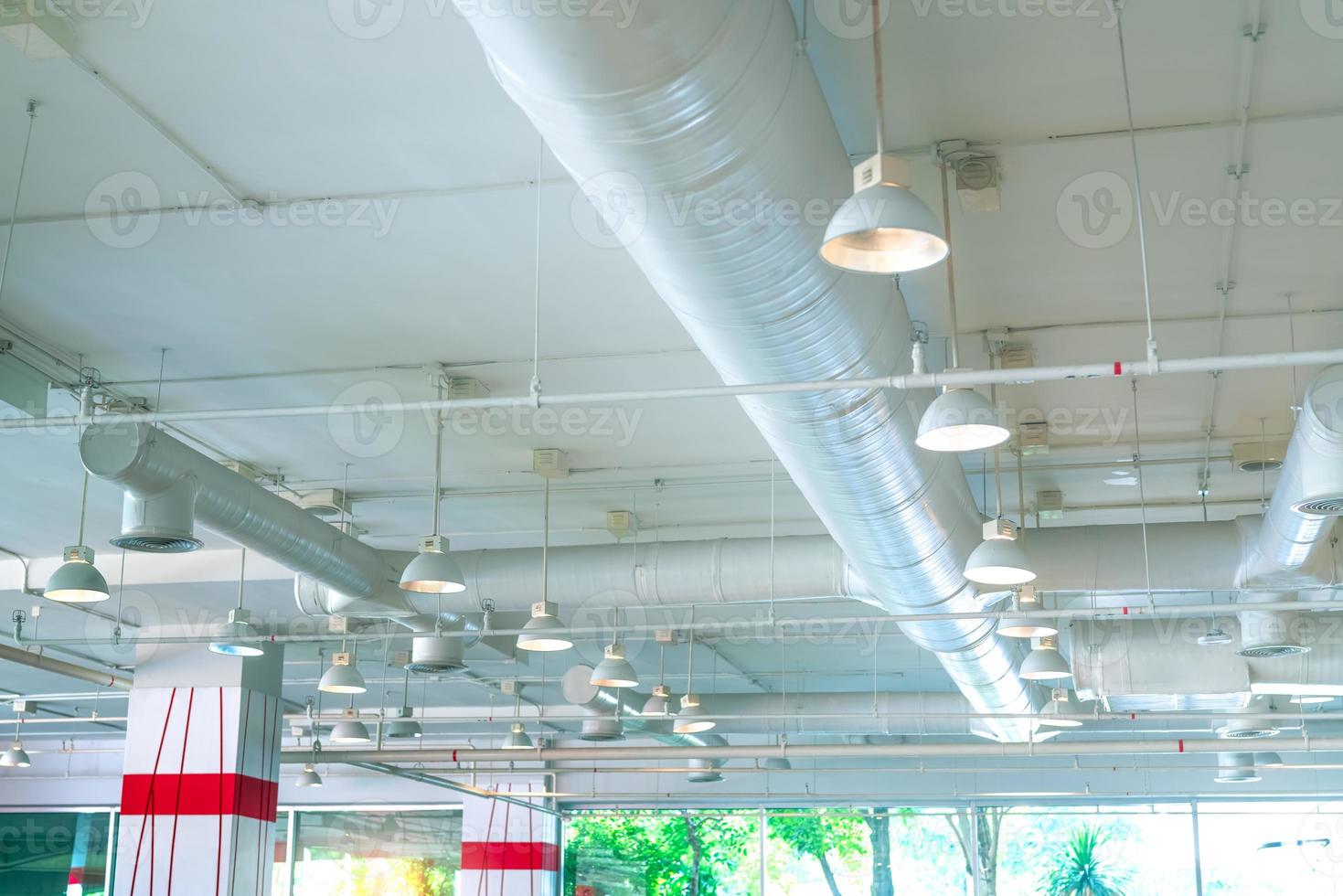 conduit d'air, tuyau de climatiseur, système de gicleurs d'incendie. circulation d'air et système de ventilation. intérieur du bâtiment. plafonnier lumière avec lumière ouverte. Architecture d'intérieur. bâtiment de mur de verre. photo