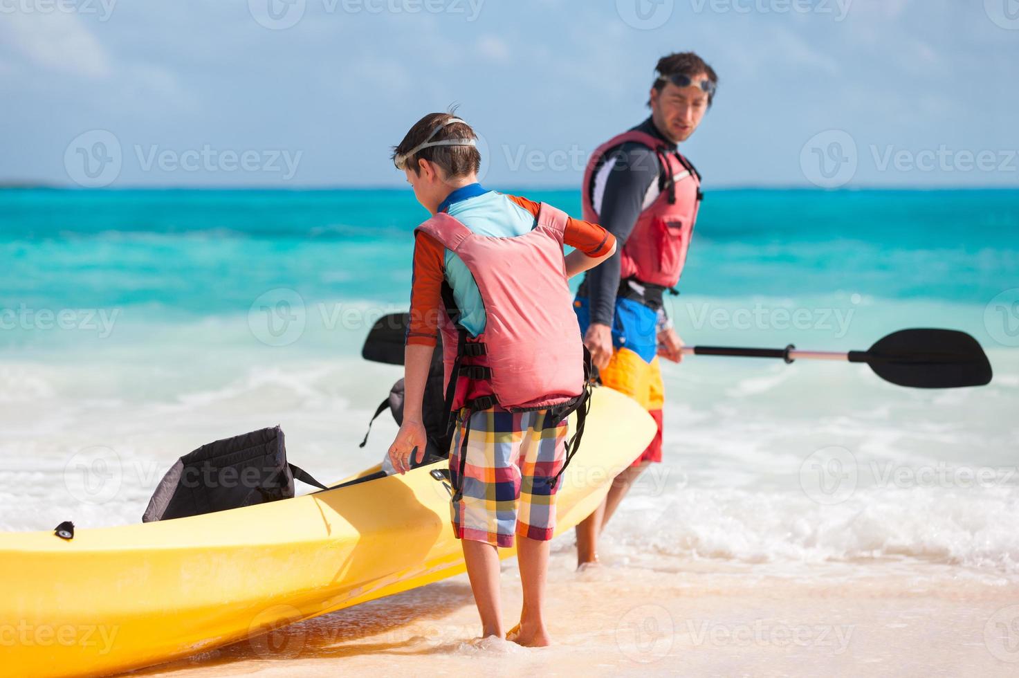 père et fils tirant sur le kayak photo