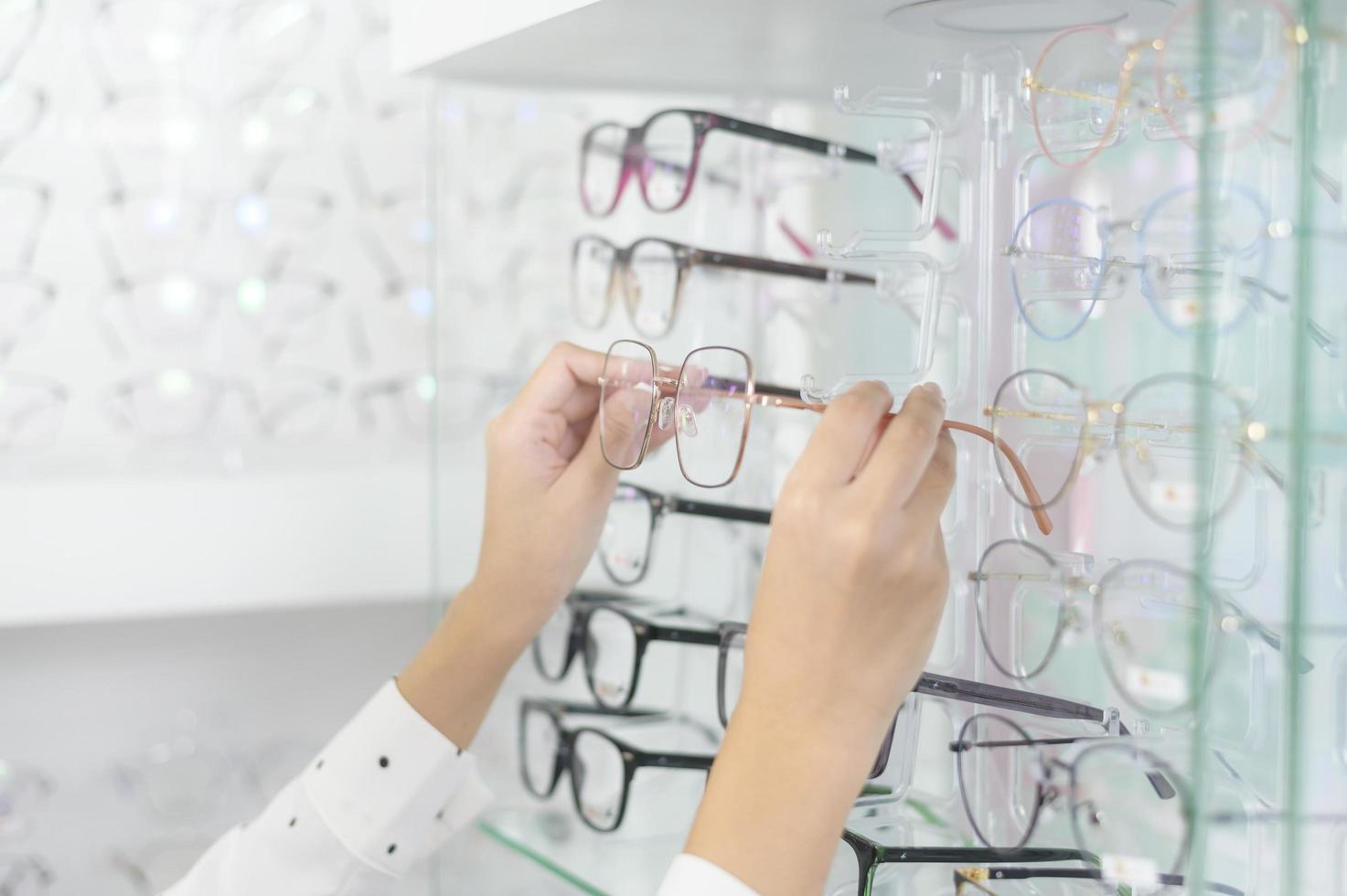 jeune cliente choisissant des lunettes dans un centre optique, concept de soins oculaires. photo