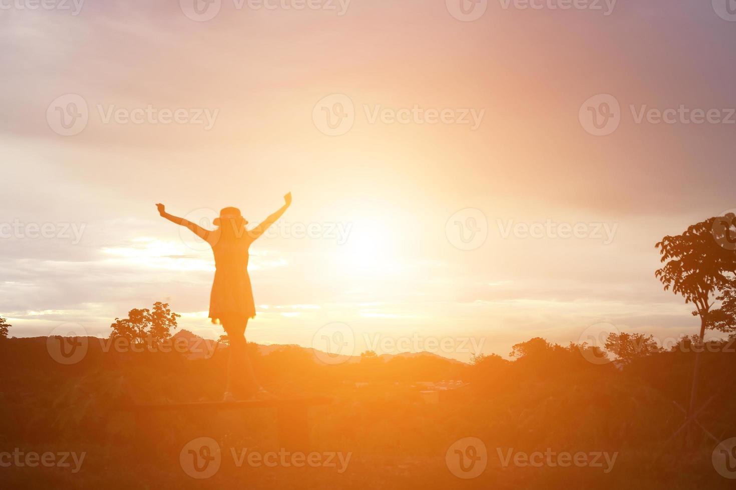 silhouette de femme priant sur fond de ciel magnifique photo