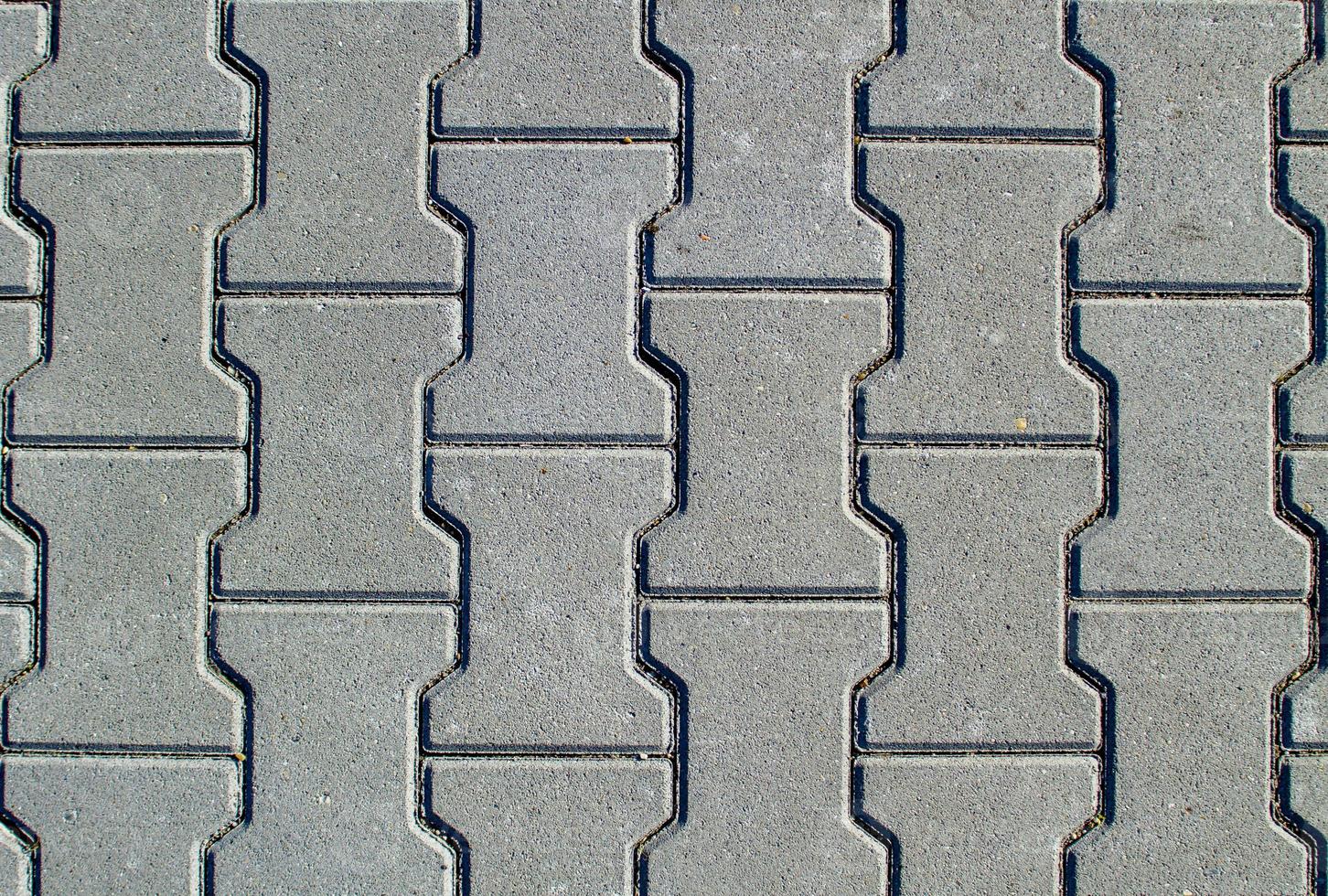 texture de la chaussée en béton ou du trottoir avec des dalles de pavage photo