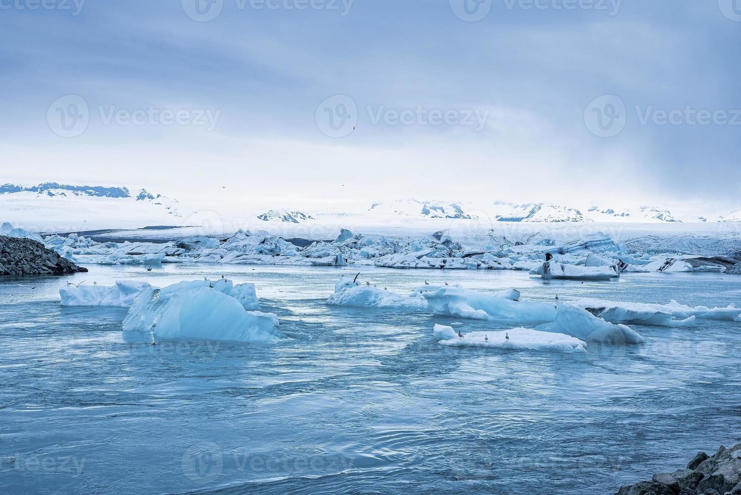 beaux icebergs flottant dans le lagon glaciaire de jokulsarlon contre le ciel bleu photo