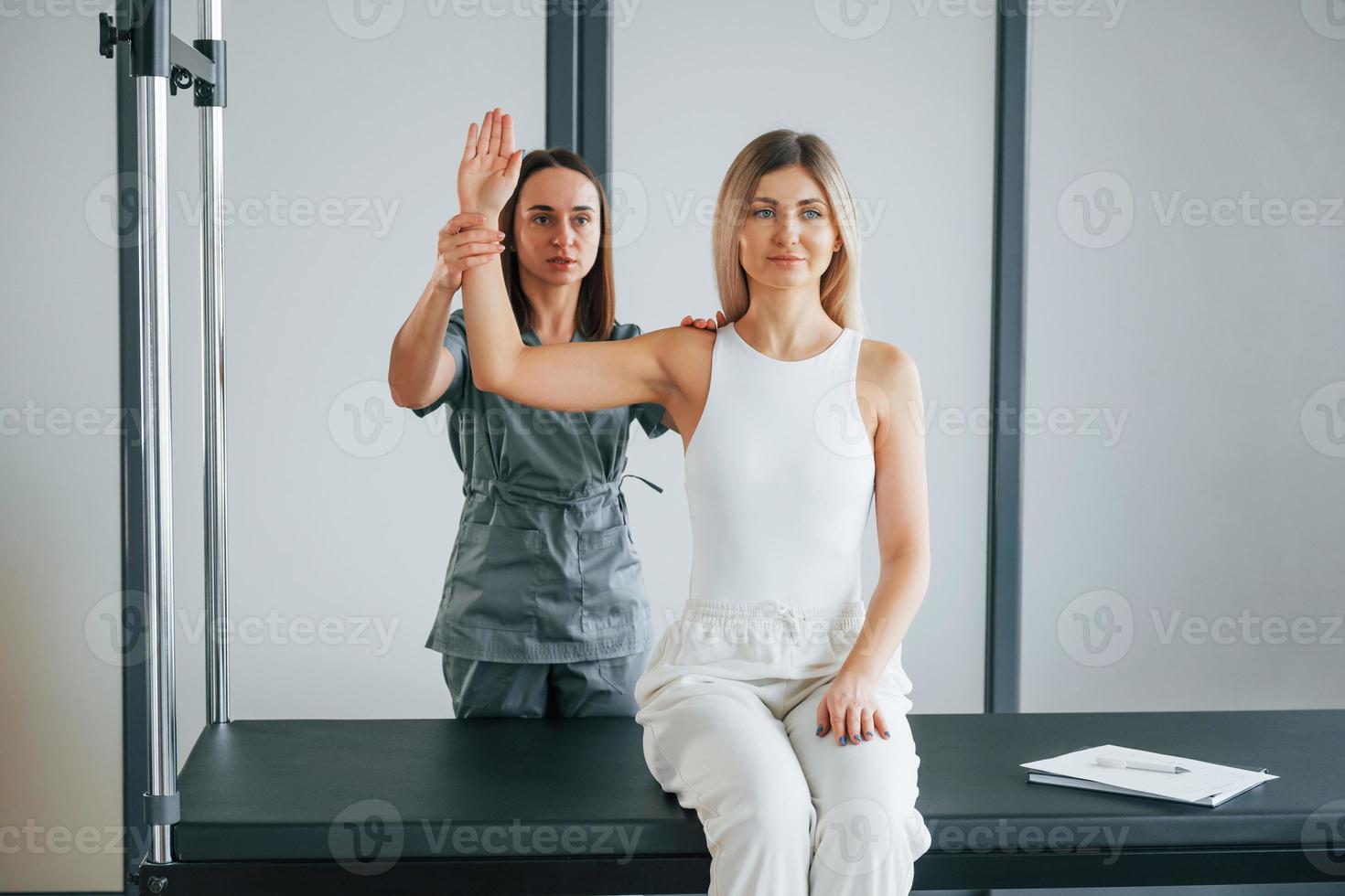 travailler avec les armes. la femme est au centre de santé et reçoit l'aide d'un médecin photo