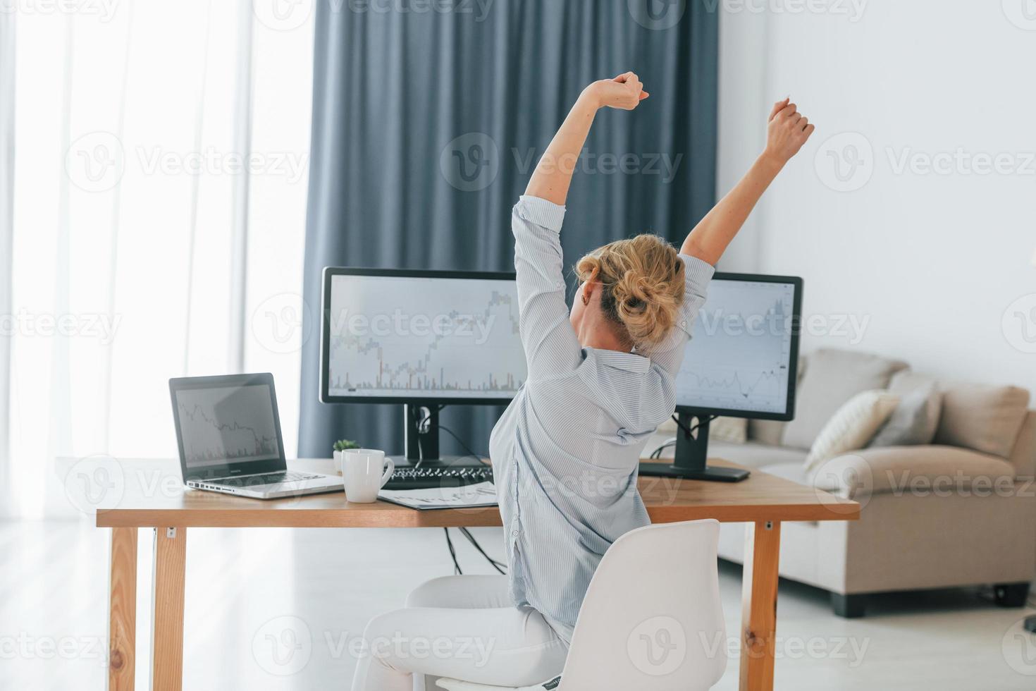 faire une pause. femme courtier en valeurs mobilières en tenue de soirée travaille au bureau photo