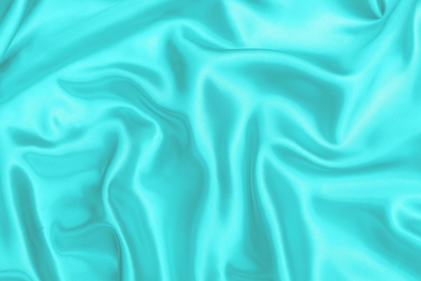 texture de tissu satiné cyan-sarcelle arrière-plan flou doux photo