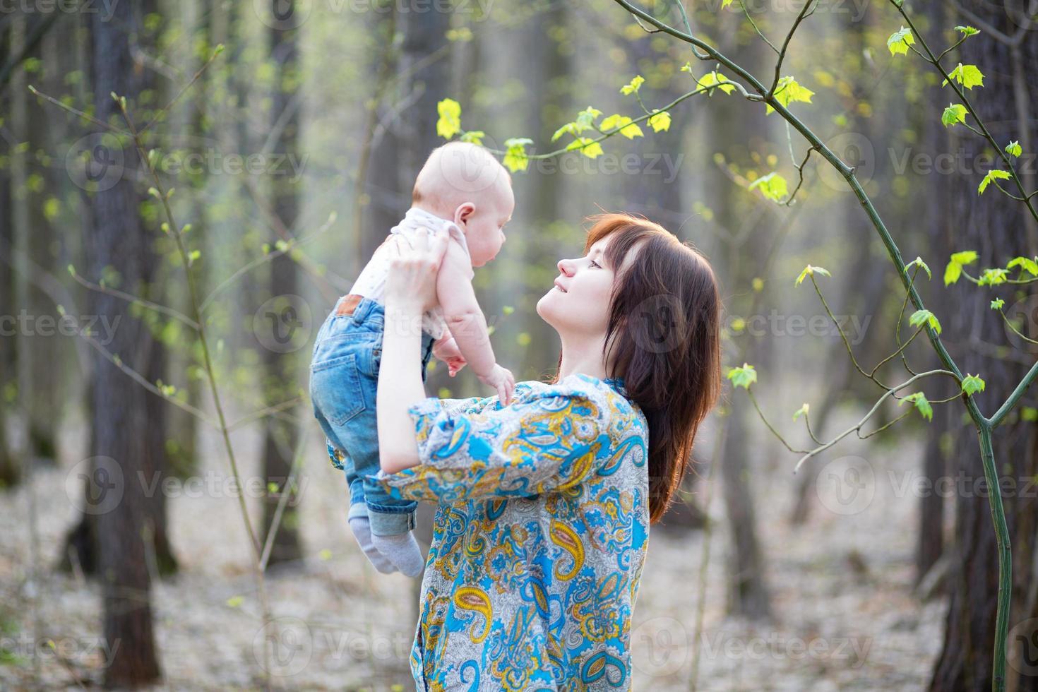 jeune maman avec son fils dans une forêt au printemps photo