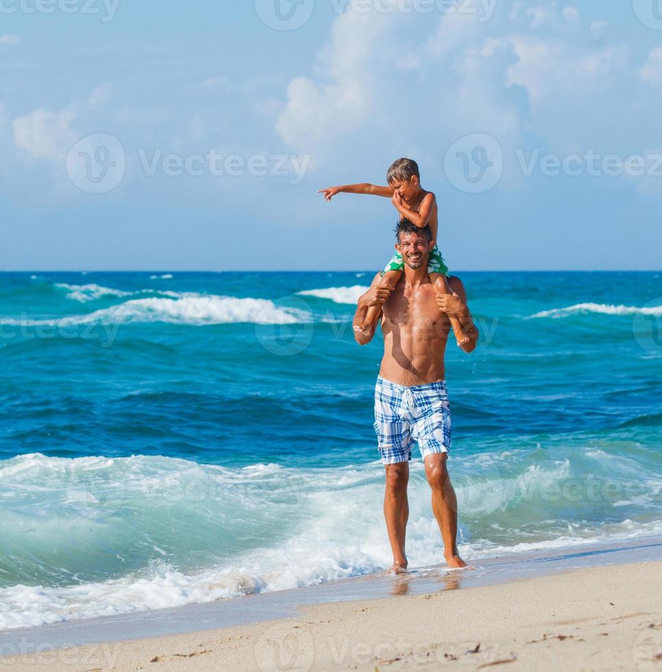 père et fils jouant dans la mer photo
