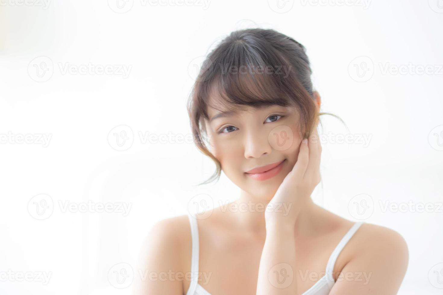 portrait d'une belle jeune femme asiatique sourire tout en se réveillant en bonne santé et bien-être avec le lever du soleil le matin dans la chambre, soins de la peau d'une fille asiatique avec un concept frais, de style de vie et de détente. photo