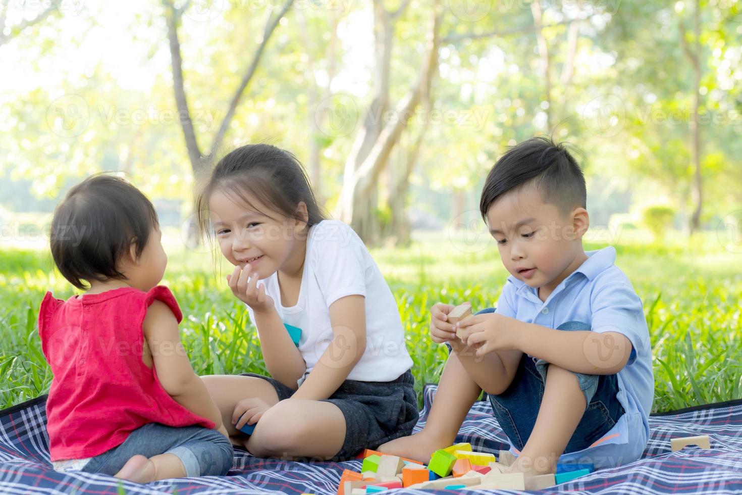 le petit garçon et la fille jouent pour l'idée et l'inspiration avec un bloc de jouets, un enfant apprend avec un bloc de construction pour l'éducation, l'activité des enfants et le jeu dans le parc avec plaisir en été. photo