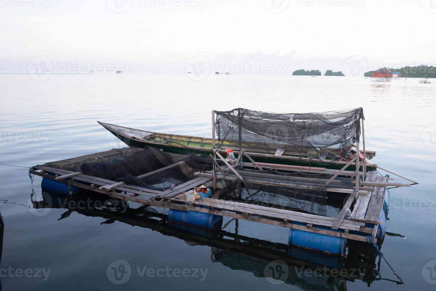 c'est le keramba, un outil traditionnel de pisciculture qui flotte au milieu de la mer, fait de filets pour élever des poissons photo