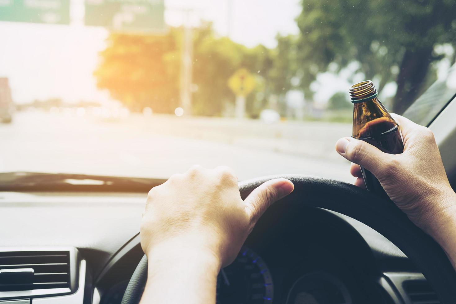 homme tenant une bouteille de boisson énergisante en conduisant une voiture photo