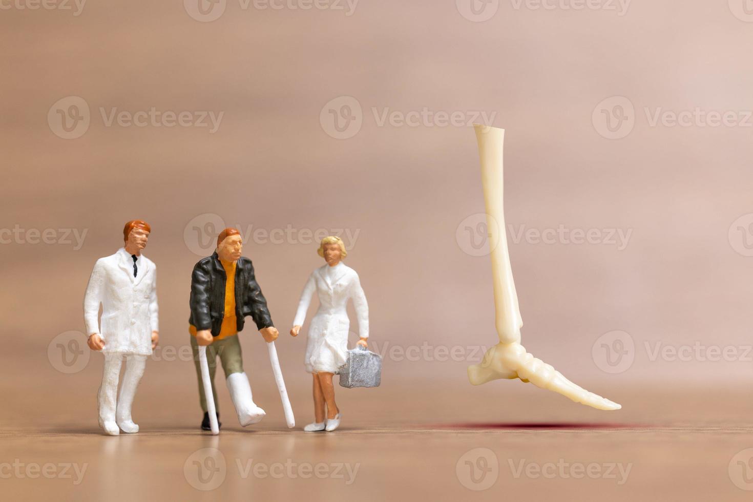 les personnes miniatures blessées aux jambes sont discutées par un médecin orthopédiste. photo