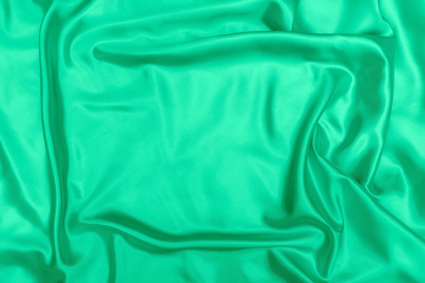 Texture de tissu satin vert doux arrière-plan flou photo