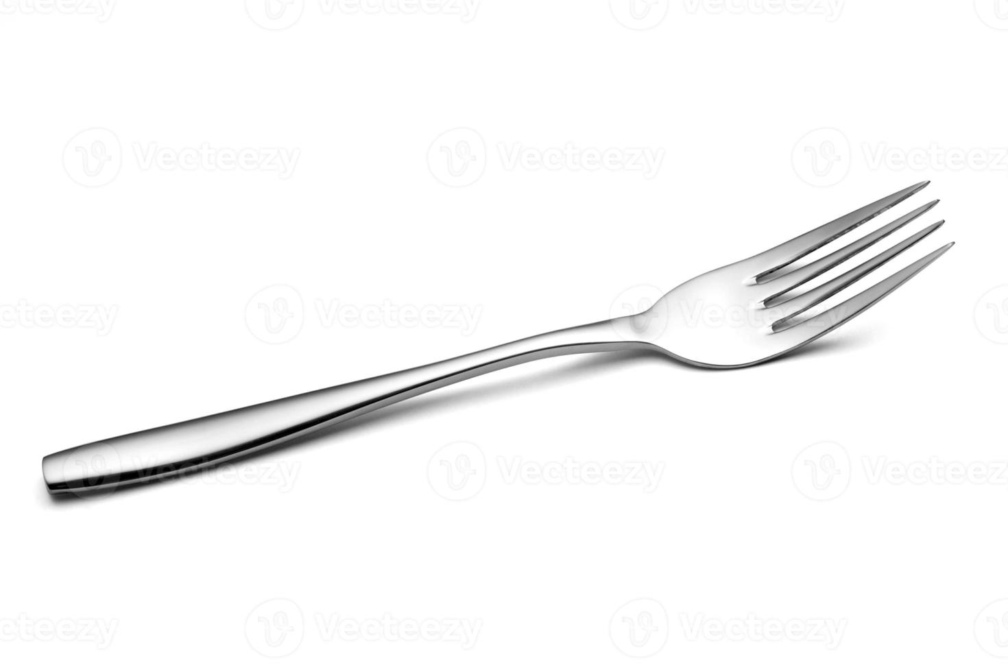 la fourchette brillante en métal sur le blanc photo