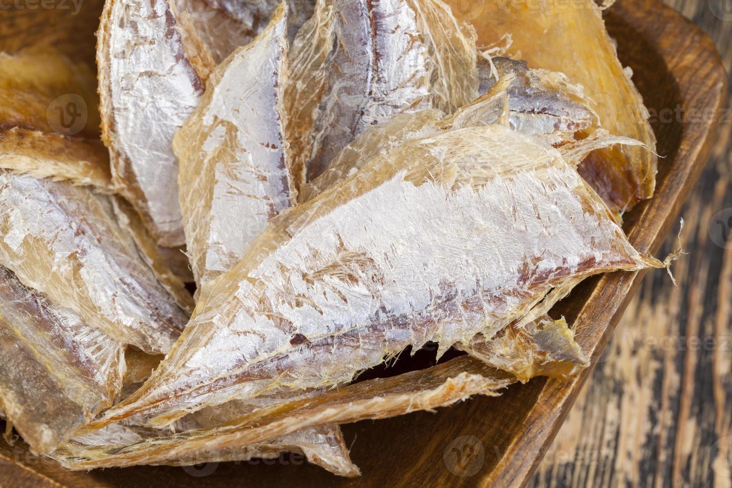 petits poissons séchés et dépecés sur une table en bois photo