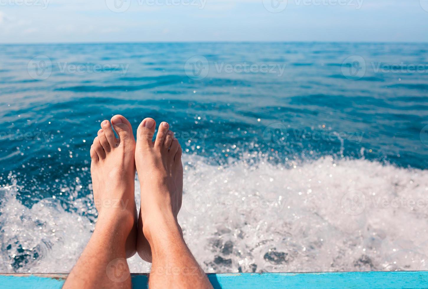paire de pieds relaxant au bord de la mer photo