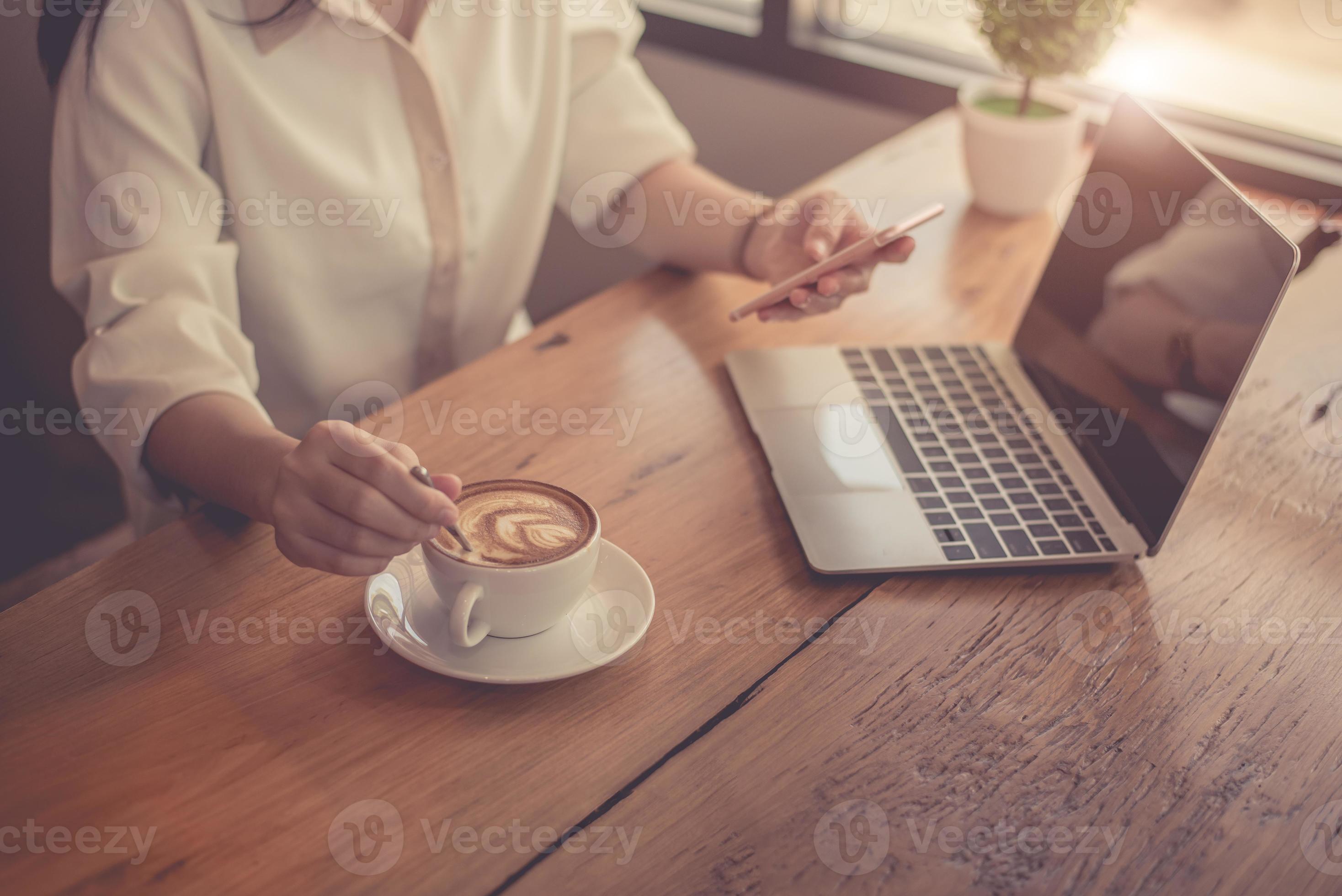 gros plan d'une femme d'affaires travaillant avec un ordinateur portable et buvant du café photo