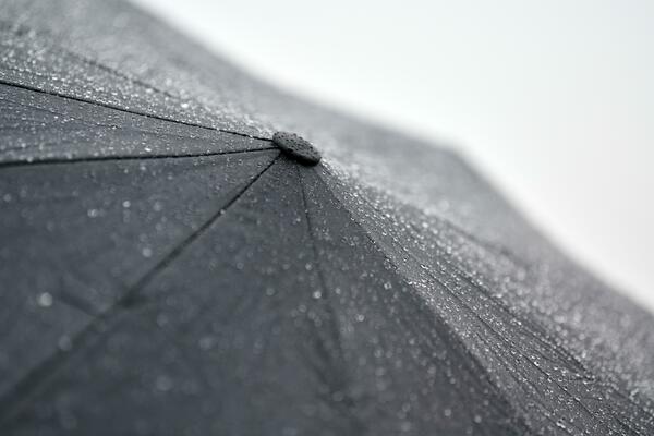parapluie noir sous la pluie. grand parapluie par mauvais temps. homme dans  la rue par temps nuageux. 13584613 Photo de stock chez Vecteezy