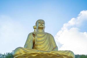 la main de la statue de bouddha doré tenant le lotus au monastère de chon khong. photo