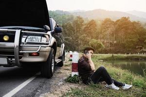 un homme essaie de résoudre un problème de moteur de voiture sur une route locale chiang mai thaïlande - les personnes ayant un problème de voiture concept de transport photo