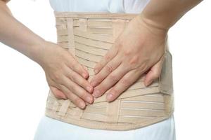 femme portant une ceinture de soutien dorsale isolée sur blanc photo