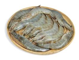 Crevettes crues avec plaque en bois isolé sur fond blanc photo