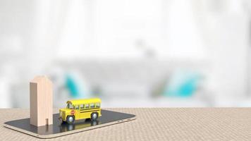 le bus scolaire et la maison en bois sur tablette pour le rendu 3d du concept d'éducation photo