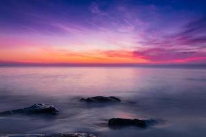 ciel coucher de soleil avec des nuages coucher de soleil spectaculaires sur la mer. beau lever de soleil sur l'océan photo