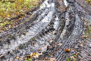 route de campagne sale avec des flaques de pluie en automne photo