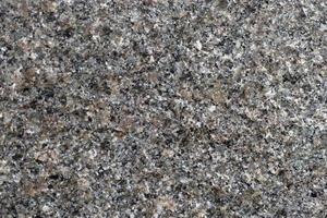 beau fond de granit gris-rouge. gros plan de pierre de granit. photo