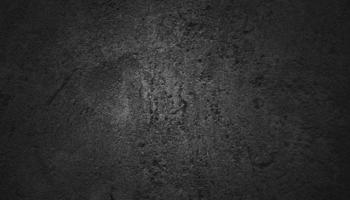 murs sombres effrayants, texture de ciment en béton noir légèrement clair pour le fond. surface sombre grunge paysage panoramique photo