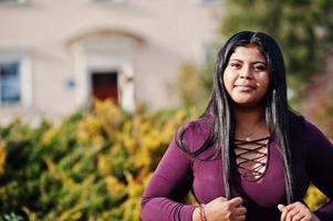 jolie fille modèle latino xxl de l'équateur portant un chemisier violet posé dans la rue. photo