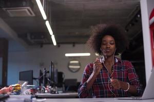 portrait d'une jeune femme afro-américaine réussie dans un bureau moderne photo