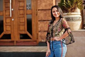 jolie fille modèle latino de l'équateur portant des jeans posés dans la rue. photo