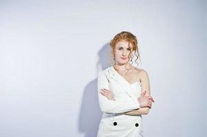 fille aux cheveux bouclés isolée sur fond de studio blanc. photo