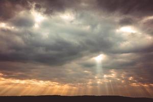 coucher de soleil avec nuages et rayons de soleil photo