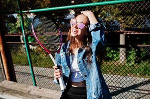 jeune joueuse sportive avec une raquette de tennis sur un court de tennis. photo