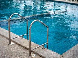 escaliers en acier inoxydable à la piscine. mains courantes de haut en bas de la piscine. photo