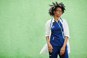 portrait d'une femme médecin afro-américaine avec stéthoscope portant une blouse de laboratoire. photo